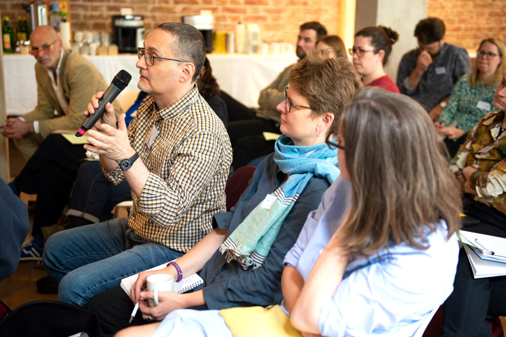 Daniel Seller (CARE Austria) with a microphone in his hand.